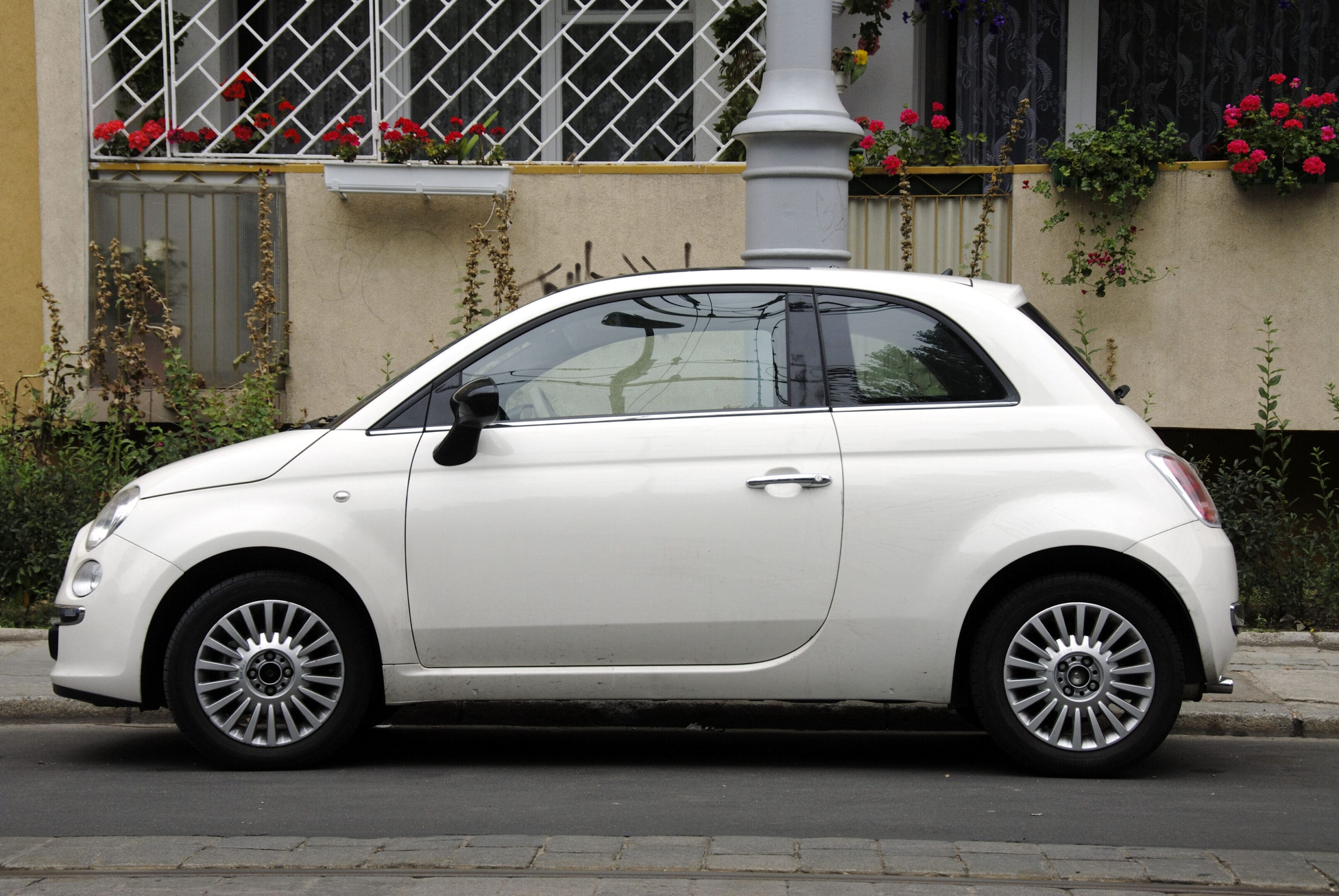 A white car parked on the side of a road.